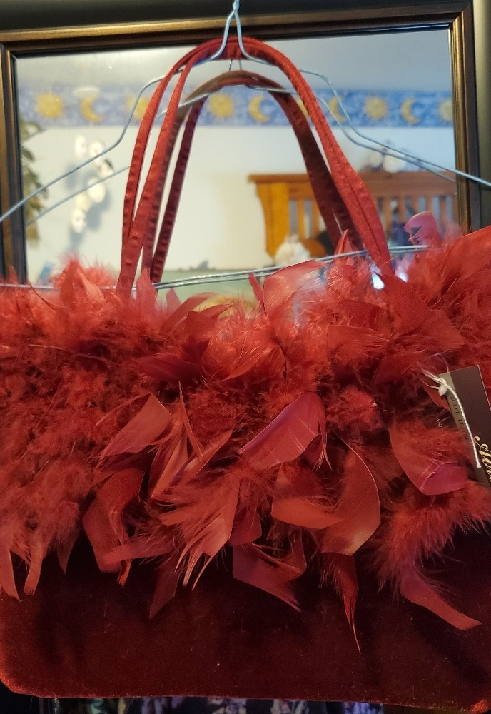 Red velvet and feather evening bag